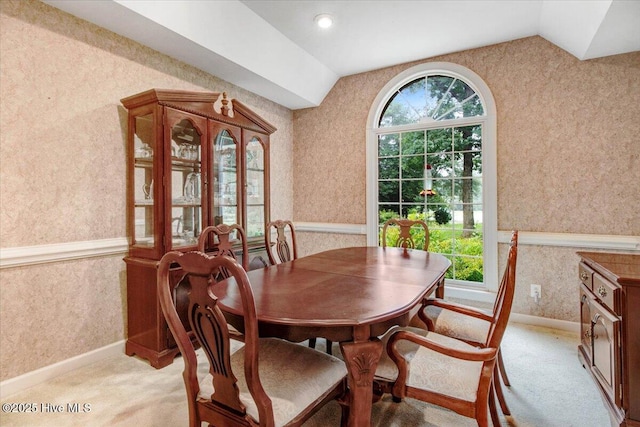 104 Tall Pines Pl, Goldsboro, NC 27534 - dining space featuring wallpapered walls, lofted ceiling, a wainscoted wall, and light carpet
