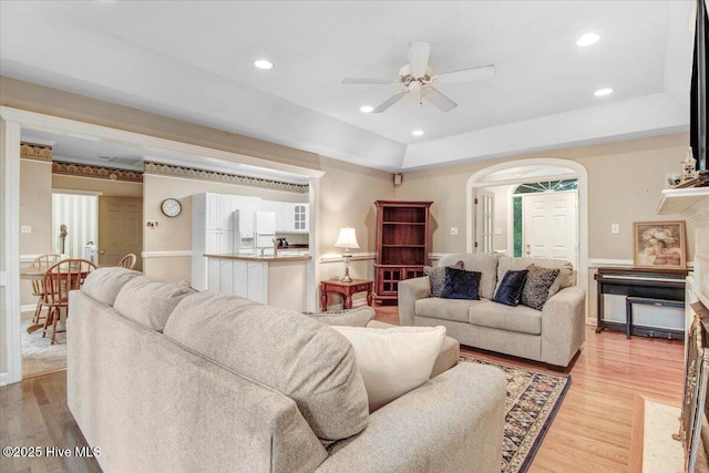 104 Tall Pines Pl, Goldsboro, NC 27534 - living room featuring ceiling fan, arched walkways, light wood-style floors, recessed lighting, and a tray ceiling
