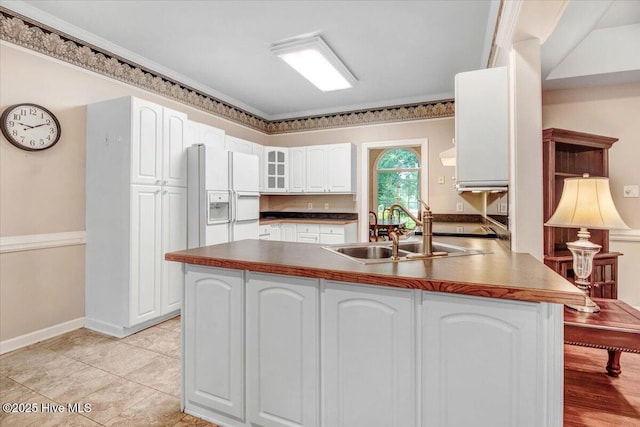 104 Tall Pines Pl, Goldsboro, NC 27534 - kitchen with white fridge with ice dispenser, a peninsula, glass insert cabinets, white cabinets, and dark countertops