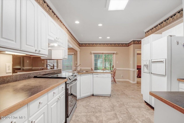 104 Tall Pines Pl, Goldsboro, NC 27534 - kitchen with white appliances, white cabinetry, a peninsula, recessed lighting, and crown molding