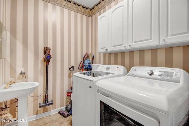 104 Tall Pines Pl, Goldsboro, NC 27534 - washroom with washing machine and dryer, wallpapered walls, and cabinet space