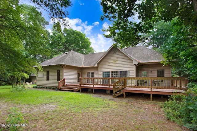 104 Tall Pines Pl, Goldsboro, NC 27534 - rear view of house featuring a lawn, a shingled roof, and a deck