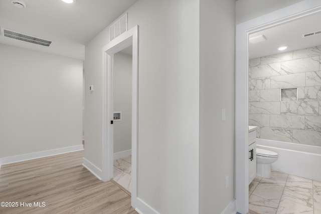 208 Triton Ln, Surf City, NC 28445 - hallway with light marble finish floors and recessed lighting