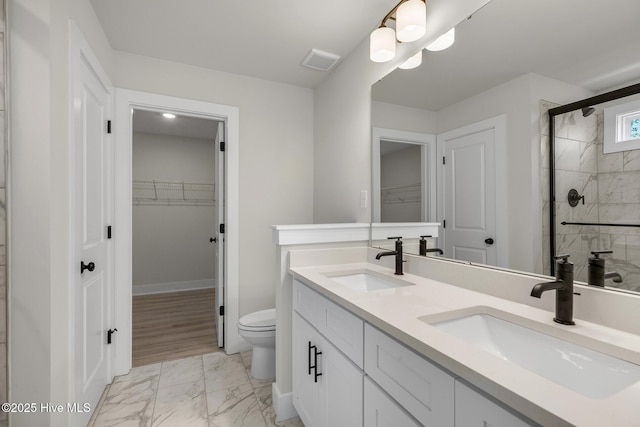 208 Triton Ln, Surf City, NC 28445 - full bath featuring a walk in closet, marble finish floors, double vanity, and a stall shower