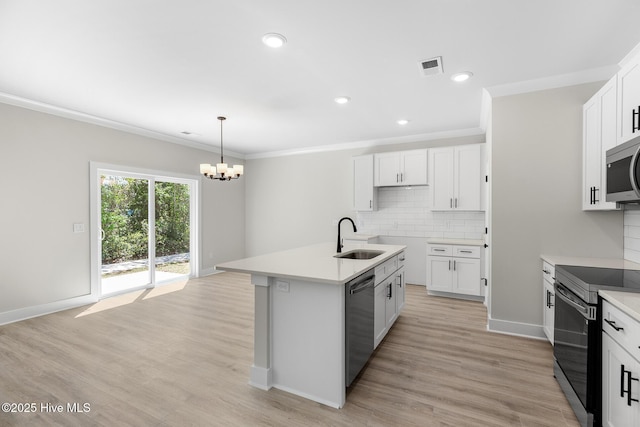 208 Triton Ln, Surf City, NC 28445 - kitchen featuring stainless steel appliances, a chandelier, backsplash, ornamental molding, and light wood finished floors