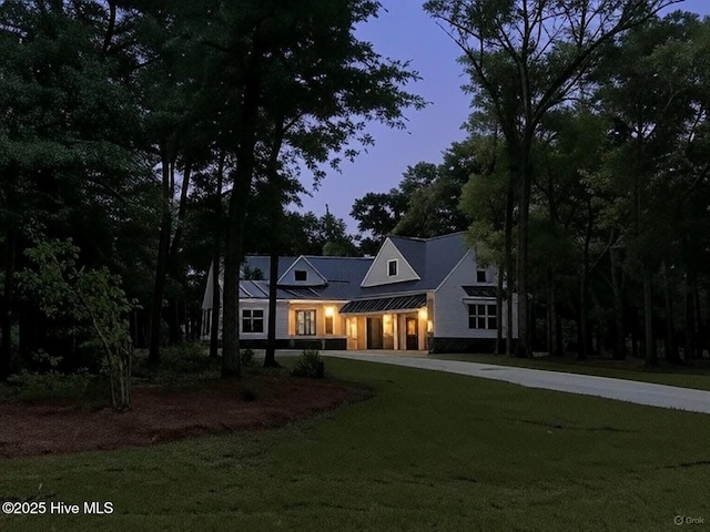 1908 Redfish SW, Supply, NC 28462 - modern inspired farmhouse featuring a lawn, a standing seam roof, driveway, and a metal roof