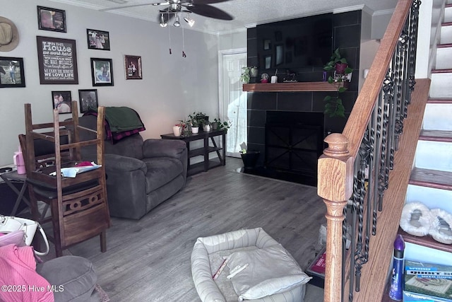 2903 Cedar Creek Rd Apt B, Greenville, NC 27834 - living room with ornamental molding, stairway, wood finished floors, a fireplace, and a ceiling fan