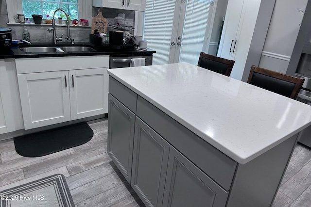 2903 Cedar Creek Rd Apt B, Greenville, NC 27834 - kitchen featuring gray cabinetry, light wood finished floors, a center island, and french doors