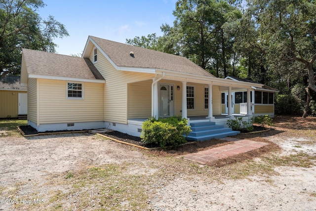 108 NW 29th St, Oak Island, NC 28465 - view of front of home featuring crawl space, a shingled roof, and covered porch