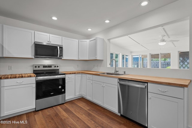 108 NW 29th St, Oak Island, NC 28465 - kitchen with wooden counters, stainless steel appliances, dark wood finished floors, ceiling fan, and recessed lighting