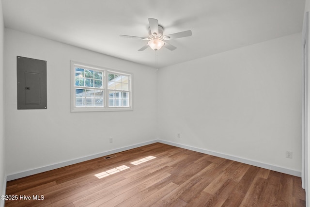 108 NW 29th St, Oak Island, NC 28465 - empty room with electric panel, a ceiling fan, and wood finished floors