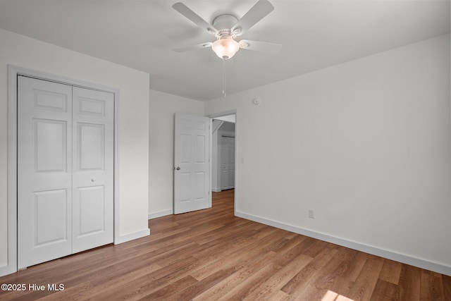 108 NW 29th St, Oak Island, NC 28465 - unfurnished bedroom featuring light wood finished floors, a closet, and ceiling fan