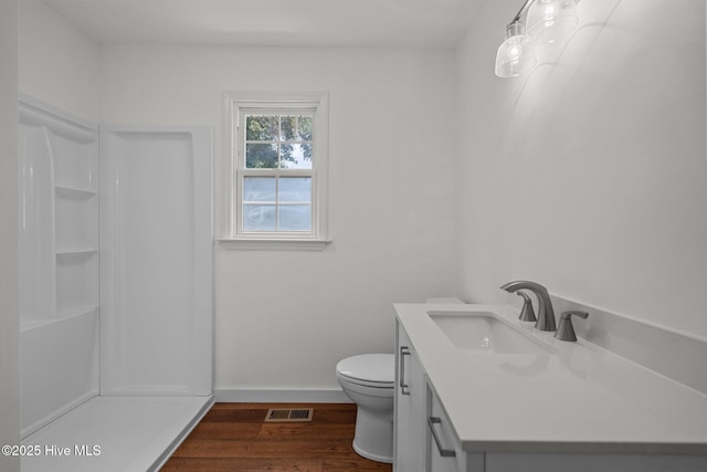 108 NW 29th St, Oak Island, NC 28465 - bathroom with vanity, a shower, and wood finished floors