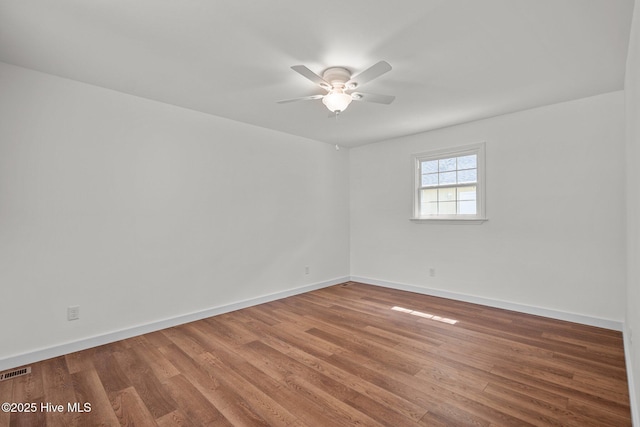 108 NW 29th St, Oak Island, NC 28465 - spare room featuring ceiling fan and wood finished floors
