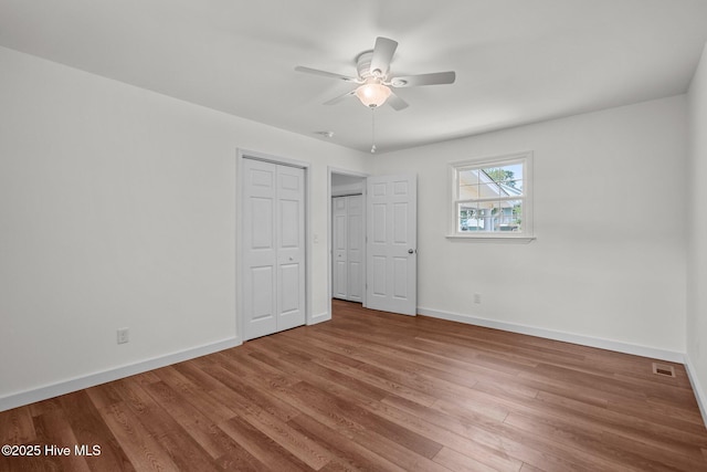 108 NW 29th St, Oak Island, NC 28465 - unfurnished bedroom with wood finished floors and a ceiling fan