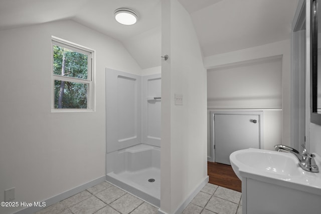 108 NW 29th St, Oak Island, NC 28465 - bathroom with tile patterned floors, vanity, a stall shower, and vaulted ceiling