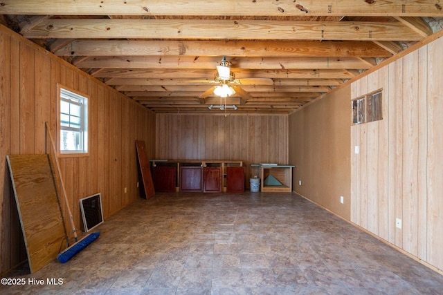 108 NW 29th St, Oak Island, NC 28465 - below grade area featuring ceiling fan and wooden walls