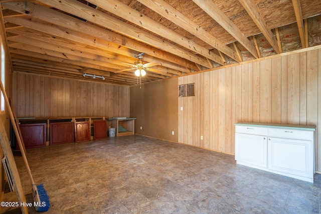 108 NW 29th St, Oak Island, NC 28465 - basement featuring wood walls and a ceiling fan
