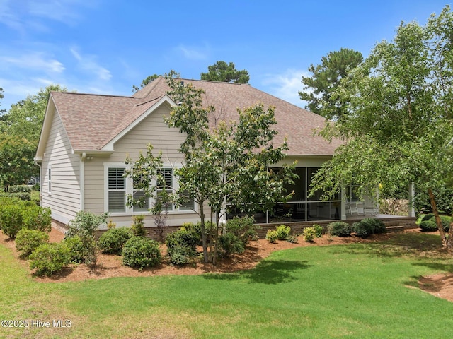 9385 Fallen Pear Ln NE, Leland, NC 28451 - view of front facade with roof with shingles, a front yard, and a sunroom