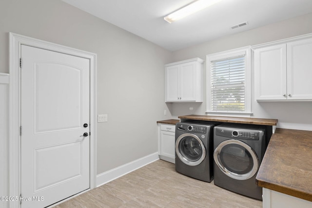 9385 Fallen Pear Ln NE, Leland, NC 28451 - laundry room featuring washing machine and dryer and cabinet space