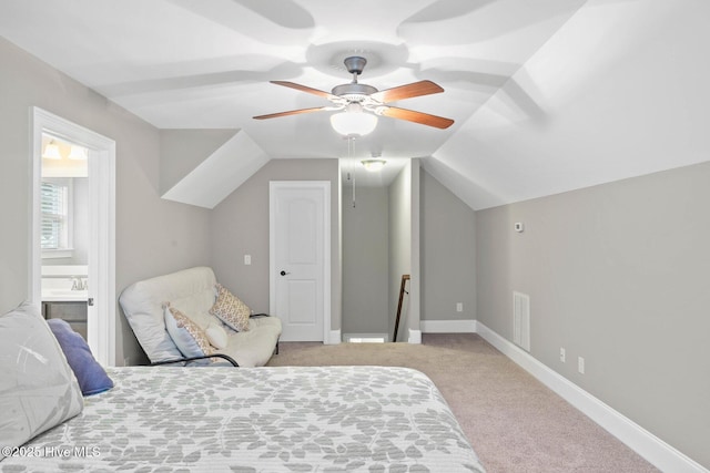 9385 Fallen Pear Ln NE, Leland, NC 28451 - carpeted bedroom featuring lofted ceiling, ensuite bath, and a ceiling fan