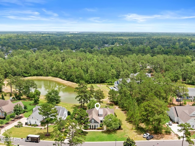 9385 Fallen Pear Ln NE, Leland, NC 28451 - aerial perspective of suburban area with a heavily wooded area and a nearby body of water