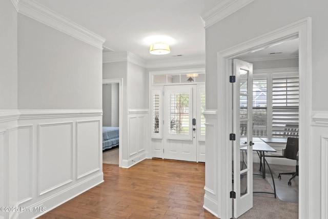 9385 Fallen Pear Ln NE, Leland, NC 28451 - entryway featuring a decorative wall, wood finished floors, ornamental molding, and wainscoting