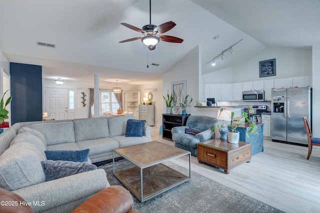 660 Pine Branches Cir SE, Leland, NC 28451 - living room featuring light wood-style flooring, a ceiling fan, high vaulted ceiling, track lighting, and ornate columns