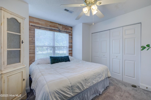 660 Pine Branches Cir SE, Leland, NC 28451 - carpeted bedroom with a closet, wooden walls, and ceiling fan