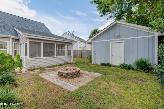 660 Pine Branches Cir SE, Leland, NC 28451 - view of yard with an outdoor fire pit, a sunroom, an outbuilding, and a patio area
