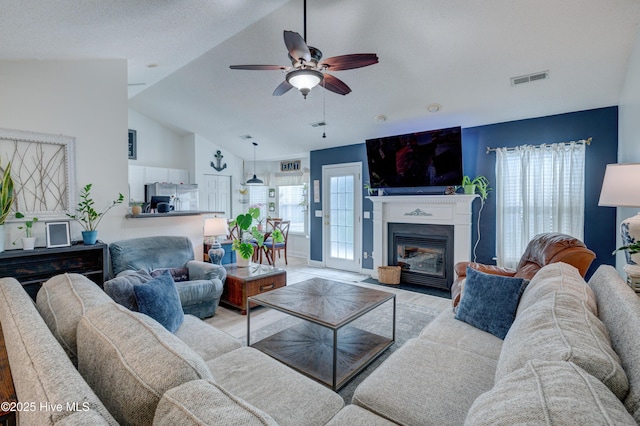 660 Pine Branches Cir SE, Leland, NC 28451 - living area with light wood-style flooring, ceiling fan, vaulted ceiling, and a fireplace with flush hearth