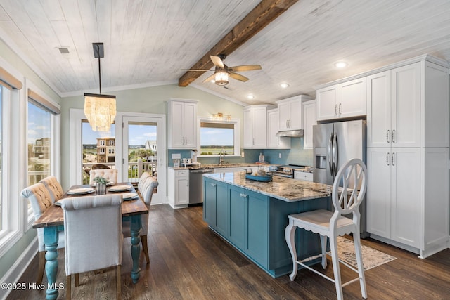 6626 W Beach Dr, Oak Island, NC 28465 - kitchen featuring stainless steel appliances, white cabinetry, a kitchen island, dark wood-type flooring, and a ceiling fan