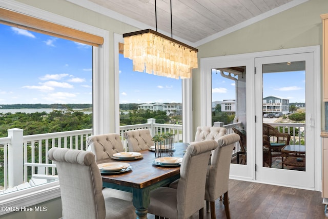6626 W Beach Dr, Oak Island, NC 28465 - sunroom featuring ornamental molding, wood finished floors, lofted ceiling, plenty of natural light, and a chandelier
