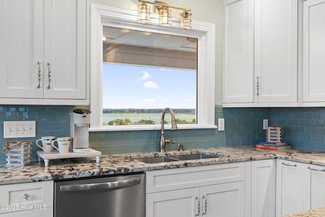 6626 W Beach Dr, Oak Island, NC 28465 - kitchen featuring stainless steel dishwasher, white cabinetry, decorative backsplash, and plenty of natural light