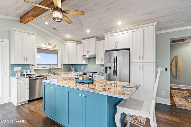 6626 W Beach Dr, Oak Island, NC 28465 - kitchen featuring stainless steel appliances, dark wood finished floors, under cabinet range hood, a ceiling fan, and wooden ceiling