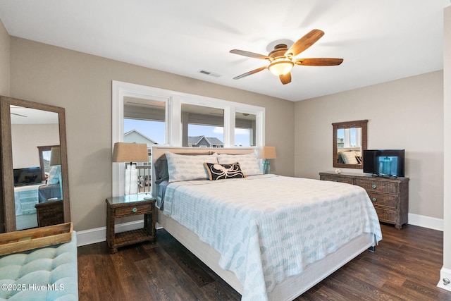 6626 W Beach Dr, Oak Island, NC 28465 - bedroom featuring dark wood-style floors and a ceiling fan