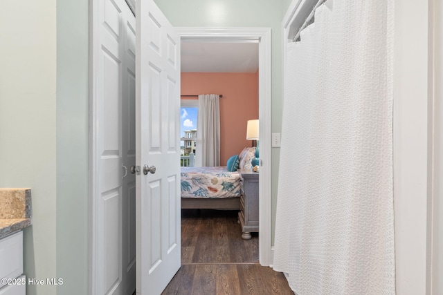 6626 W Beach Dr, Oak Island, NC 28465 - hall featuring dark wood-type flooring