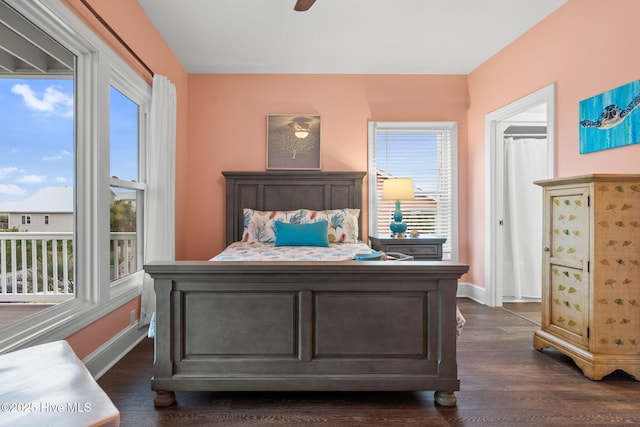 6626 W Beach Dr, Oak Island, NC 28465 - bedroom with dark wood finished floors and a ceiling fan