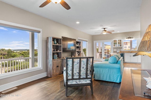 6626 W Beach Dr, Oak Island, NC 28465 - living area with ceiling fan, healthy amount of natural light, wood finished floors, and recessed lighting