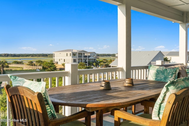 6626 W Beach Dr, Oak Island, NC 28465 - balcony featuring outdoor dining space and a water view