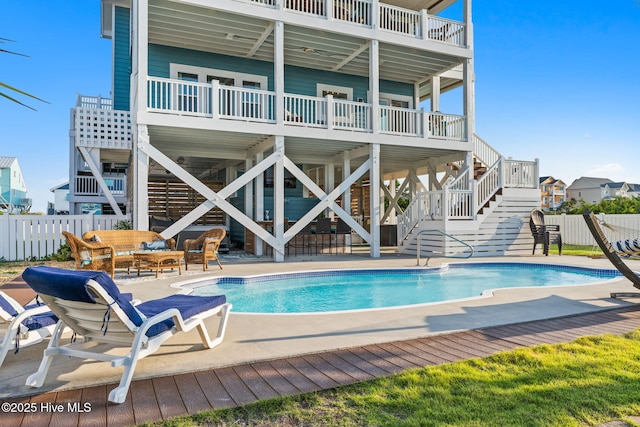 6626 W Beach Dr, Oak Island, NC 28465 - view of pool featuring stairs, a patio area, and an outdoor hangout area