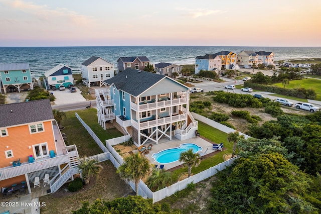 6626 W Beach Dr, Oak Island, NC 28465 - aerial view at dusk of view of pool area and a water view