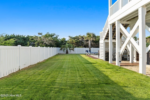 6626 W Beach Dr, Oak Island, NC 28465 - fenced backyard featuring stairway and a patio