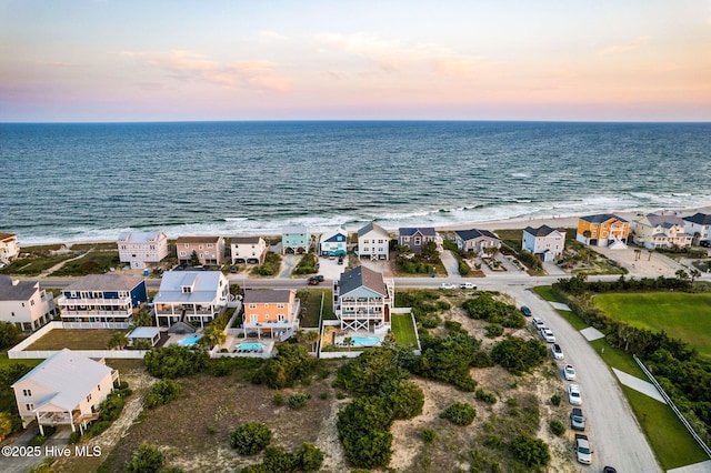 6626 W Beach Dr, Oak Island, NC 28465 - aerial view at dusk of view of water and beach and a residential view