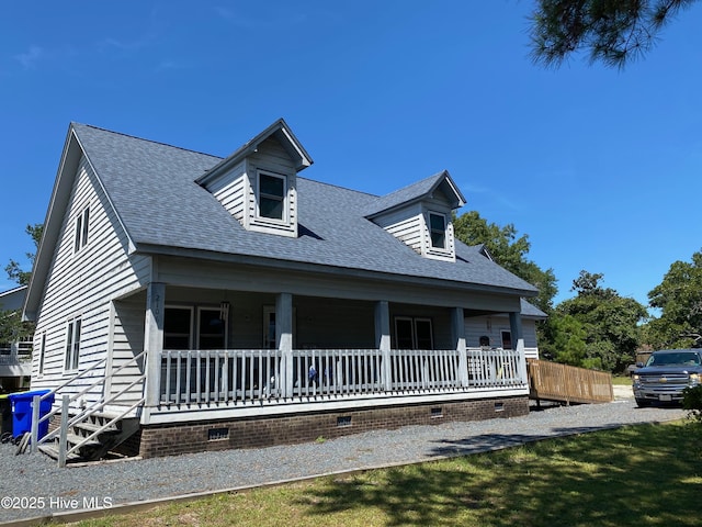 2106 E Oak Island Dr, Oak Island, NC 28465 - view of front of property with crawl space, covered porch, and a shingled roof