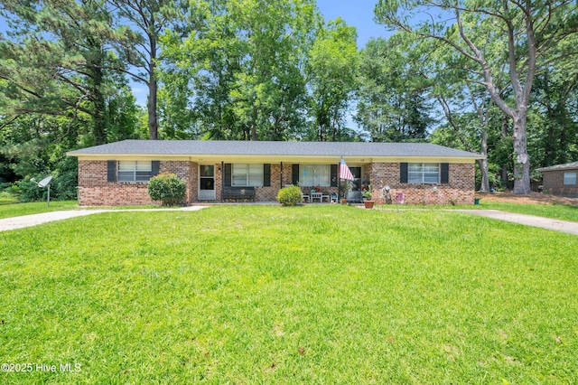 ranch-style home with a front yard, brick siding, and a porch