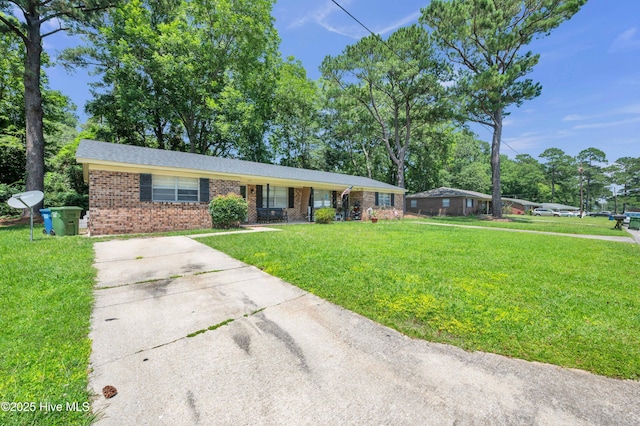 single story home featuring a front lawn, concrete driveway, and brick siding