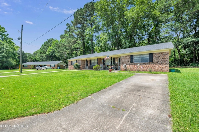single story home with a front lawn and brick siding