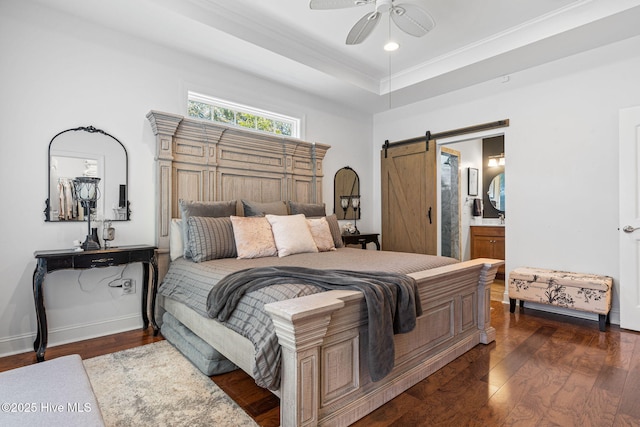 3710 Calla Lilly Ct, Southport, NC 28461 - bedroom with a barn door, dark wood-type flooring, crown molding, connected bathroom, and a ceiling fan