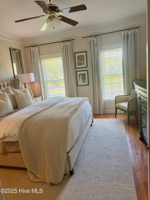 280 Green Forest Cir, Dunn, NC 28334 - bedroom featuring crown molding, multiple windows, wood finished floors, and a ceiling fan